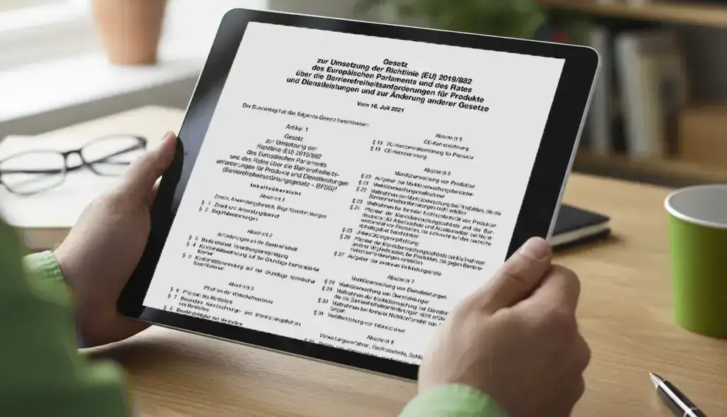 260407_UX_Gesetze_flach Tablet in den Händen einer Person mit geöffneter Seite eines juristischen Dokuments